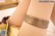 A close up of a woman's legs wearing a bracelet.