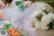 A woman laying on the ground with a bouquet of flowers.